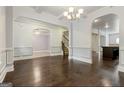 Spacious living room featuring hardwood floors, white trim, and elegant chandelier at 416 Fairway Dr, Acworth, GA 30101
