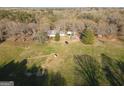 A picturesque aerial view of a home, showcasing its expansive yard and proximity to mature trees at 75 Price W Dr, Locust Grove, GA 30248