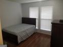 Bedroom with hardwood floor and neutral decor, offering a peaceful retreat with natural light at 3248 Brisbane Way, Lithonia, GA 30038