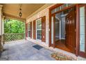 Inviting front porch with brick accents and an open door revealing gleaming hardwood floors at 4311 Hampton Mill Pkwy, Douglasville, GA 30135