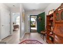 Bright entryway with wood-look floors, open door, and decorative shelving at 1152 Strath Clyde Way, Mcdonough, GA 30253
