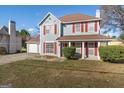 Charming two-story home with red shutters, light blue siding, and a well-manicured lawn at 453 Camp Hill Ln, Jonesboro, GA 30238