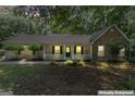 Charming single-story home featuring a stone facade, inviting front porch and nicely landscaped front yard at 380 Peach Drive, Mcdonough, GA 30253