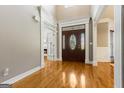 Welcoming foyer with hardwood floors, ornate trim and a decorative front door at 1360 Mount Mckinley Dr, Grayson, GA 30017