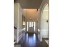 Bright foyer with hardwood floors, high ceilings, and decorative wainscoting leading to a paneled front door at 160 Elysian Dr, Fayetteville, GA 30214
