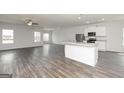 Bright, open-concept living space featuring hardwood floors and views into the modern kitchen at 256 Oliver Dr, Locust Grove, GA 30248