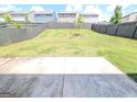 Large backyard with a wooden privacy fence and a newly planted tree at 120 Magnaview Dr, Mcdonough, GA 30253
