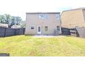 Back exterior featuring a well maintained yard with dark wood privacy fence at 120 Magnaview Dr, Mcdonough, GA 30253