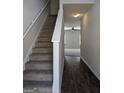 Entryway with carpeted stairs and view of hardwood floors to the living room at 120 Magnaview Dr, Mcdonough, GA 30253