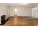 Spacious living room showcasing hardwood floors, a fireplace, and neutral paint at 3796 Wolverton Cir, Lithonia, GA 30038