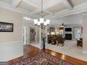 Spacious living room with hardwood floors, decorative columns and trim, with an open view to the Gathering room at 409 Brandy Ln, Mcdonough, GA 30253