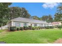Charming home with manicured front lawn and colorful shrubbery offering great curb appeal at 85 London Ln, Sharpsburg, GA 30277