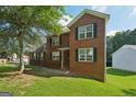 Classic brick residence with a symmetrical facade, enhanced by lush landscaping and greenery at 2326 Sand Dollar Sw Ct, Atlanta, GA 30331