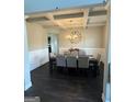 Elegant dining room with coffered ceilings and a stylish chandelier at 64 N Village Cir, Rydal, GA 30171