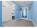 Bright foyer with gray plank flooring and an open doorway to a bedroom and an exterior door at 400 Plainfield St, Fayetteville, GA 30215