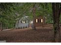 Charming home featuring a mix of brick and siding, nestled among mature trees and lush foliage at 161 Bradford Pl, Stockbridge, GA 30281