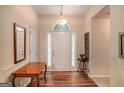 Inviting foyer showcasing beautiful wood floors, a bright entry door and detailed trim work at 161 Bradford Pl, Stockbridge, GA 30281