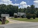 Charming two-story home with well-manicured lawn and mature trees, providing excellent curb appeal at 180 Cooper Rd, Social Circle, GA 30025