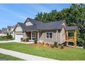 Craftsman home boasts an attached garage, covered front porch, and a waterside covered deck for outdoor enjoyment at 301 Retreat Way, Carrollton, GA 30116