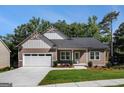 Charming single-story house features a well-maintained lawn, attached garage, and inviting front porch with craftsman details at 301 Retreat Way, Carrollton, GA 30116