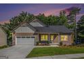 Charming single-story house features a well-maintained lawn, attached garage, and inviting front porch with craftsman details at 301 Retreat Way, Carrollton, GA 30116