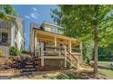 Charming home exterior with stone landscaping and spacious covered porch at 5106 N Pratt St, Covington, GA 30014