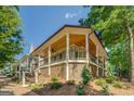 Angle view of house exterior with porch, wood ceiling, and landscaping at 5106 N Pratt St, Covington, GA 30014