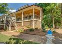 House exterior with covered porch, wood ceiling, and stone landscaping at 5106 N Pratt St, Covington, GA 30014