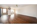 Bright living room boasts hardwood floors, a ceiling fan, and ample natural light at 6517 Snowbird Ln, Douglasville, GA 30134