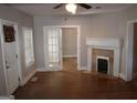Living room with hardwood floors, fireplace, and doorway with glass french doors at 1627 Orlando Sw St, Atlanta, GA 30311