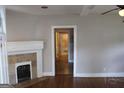 Living room with hardwood floors, fireplace, and view through the doorway of the bathroom at 1627 Orlando Sw St, Atlanta, GA 30311