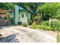 Beautifully landscaped home with private driveway and lush greenery surrounding the property at 216 Leyden St, Decatur, GA 30030