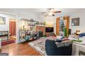 Inviting living room with hardwood floors, exposed brick fireplace, and stylish decor at 216 Leyden St, Decatur, GA 30030