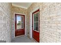 Welcoming front porch features double doors, brick walls, and elegant trim at 121 Chattahoochee Circle, Locust Grove, GA 30248