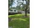 Split level home with lawn and shrubs at 268 Rountree Rd, Riverdale, GA 30274