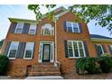 Traditional brick home with black shutters and an arched window above the front door at 165 Mcelwaney Way, Fayetteville, GA 30215