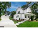 Beautiful two-story home with a charming front porch and a detached two-car garage at 61 Main St, Moreland, GA 30259