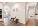 Inviting foyer with shiplap accent wall, stylish bench seating, and views to the dining and bedroom at 61 Main St, Moreland, GA 30259