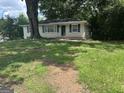 Charming brick home featuring a well-maintained lawn and beautiful mature trees for added curb appeal at 3129 Se Nursery Se Rd, Smyrna, GA 30082