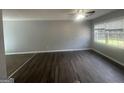 Spacious living room featuring new floors, large windows, and a ceiling fan at 8427 Fredericksburg Ct, Jonesboro, GA 30238