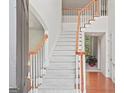 Bright foyer featuring a carpeted staircase, hardwood flooring and white trim at 3688 Eagles Beek Cir, Lithonia, GA 30038
