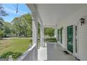Relax on the porch swing with views of the manicured lawn and serene neighborhood at 871 Clearwater Rd, Sharpsburg, GA 30277