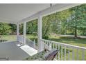 Enjoy the view from this covered porch with a comfortable cushioned swing at 871 Clearwater Rd, Sharpsburg, GA 30277