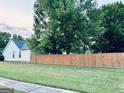 The backyard features a wood fence and large trees at 486 Village Cir, Stockbridge, GA 30281