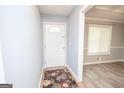 Inviting entryway with a decorative rug and view into the adjacent dining room at 611 Bernhard Rd, Fayetteville, GA 30215