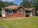 Charming brick home with a welcoming screened front porch and manicured lawn at 611 Bernhard Rd, Fayetteville, GA 30215