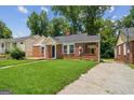 Well-maintained brick house with a green lawn and covered carport space at 1381 Sharon Sw St, Atlanta, GA 30314