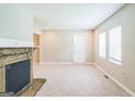 Spacious living room with a cozy stone fireplace, neutral paint, and ample natural light at 1381 Sharon Sw St, Atlanta, GA 30314