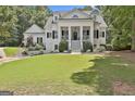 Inviting white home with a grand, columned entrance, well-maintained lawn, and classic design at 275 Sidney Ln, Fayetteville, GA 30215