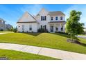 Charming two-story home features a covered front porch and nicely landscaped front yard at 604 Francis Ave, Peachtree City, GA 30269
